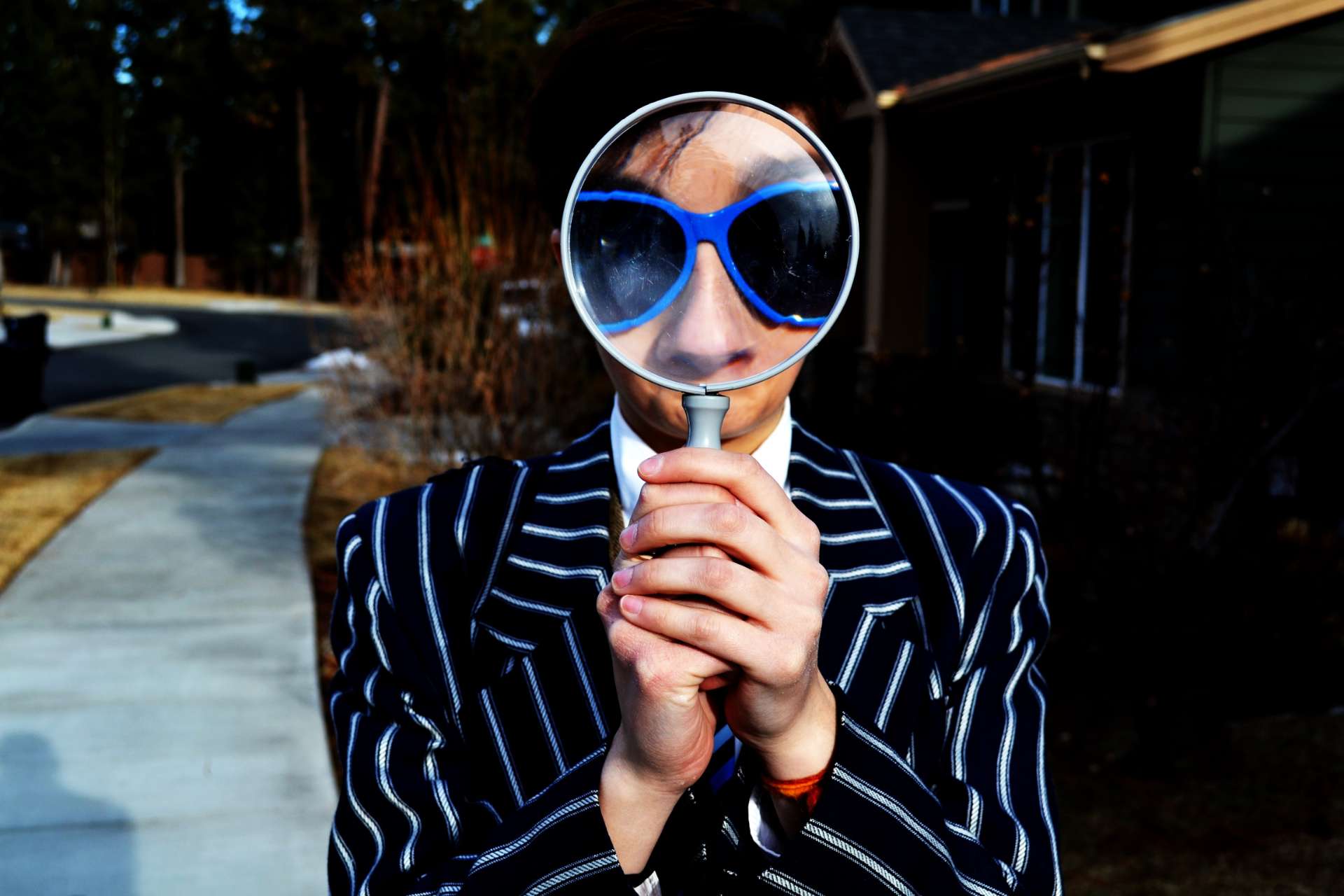 Magnifying Glass Woman holding a magnifying glass close to her face